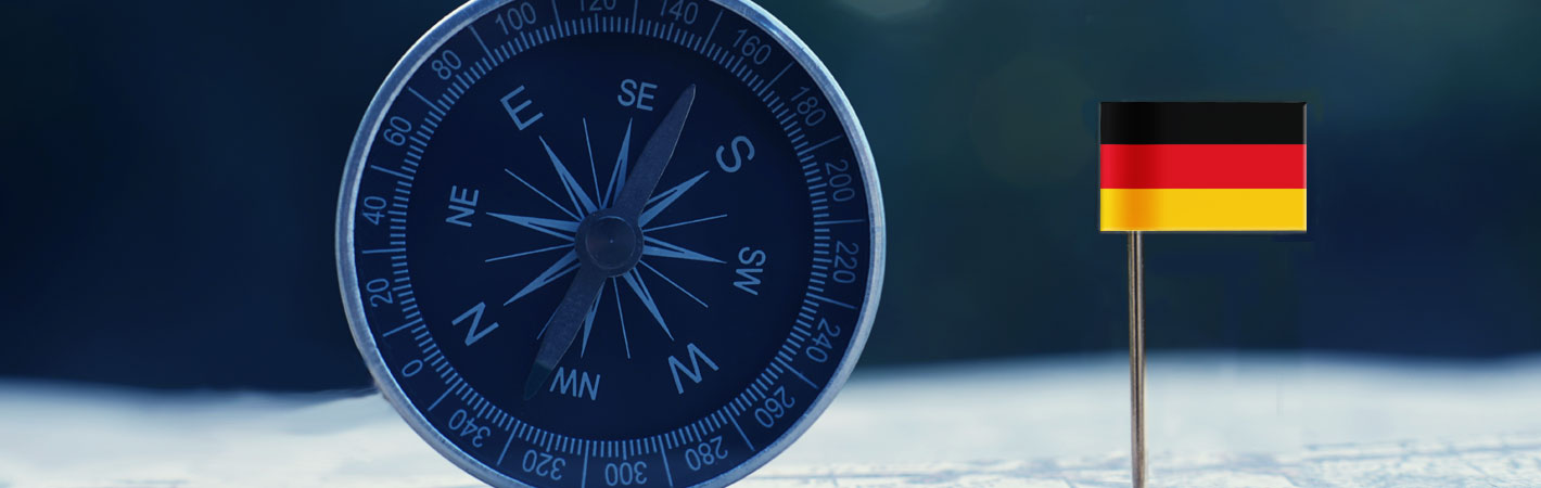 close-up view of a compass and a German flag